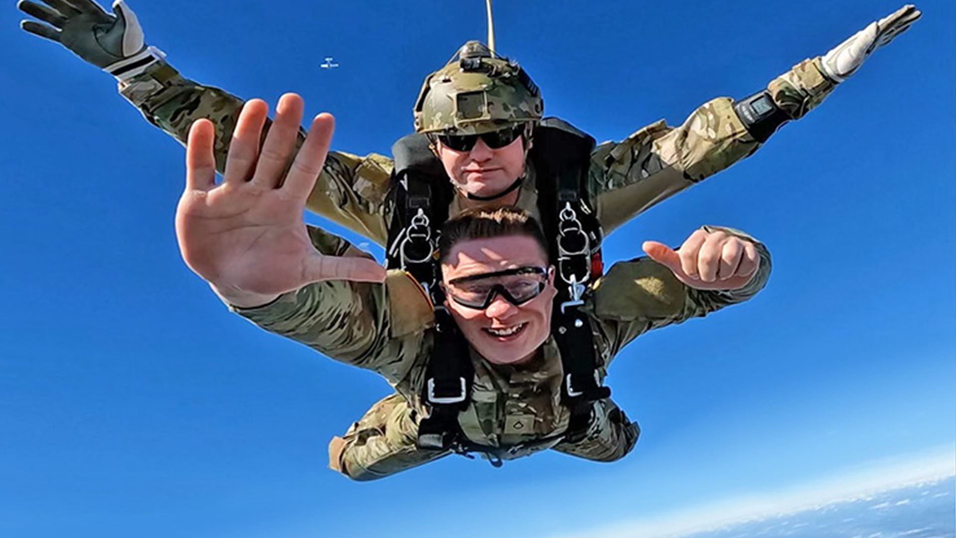 Military tandem skydiver over Skydive Spaceland